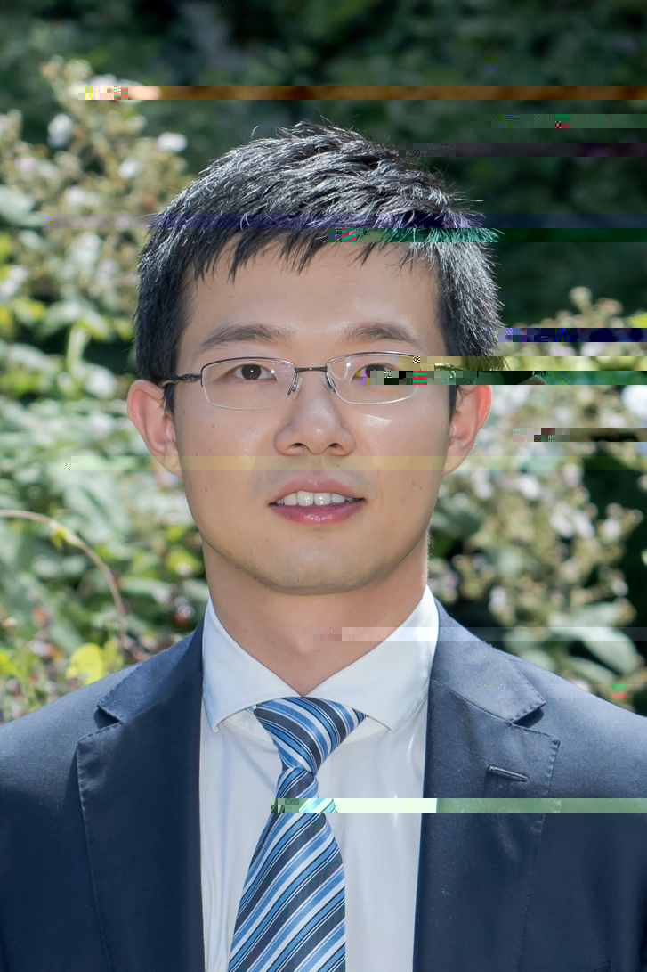 A person wearing glasses and a suitDescription automatically generated with medium confidence